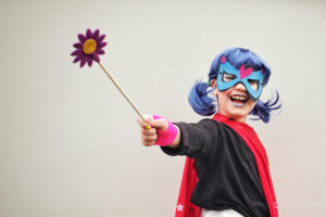 Young girl dressed up as a superhero